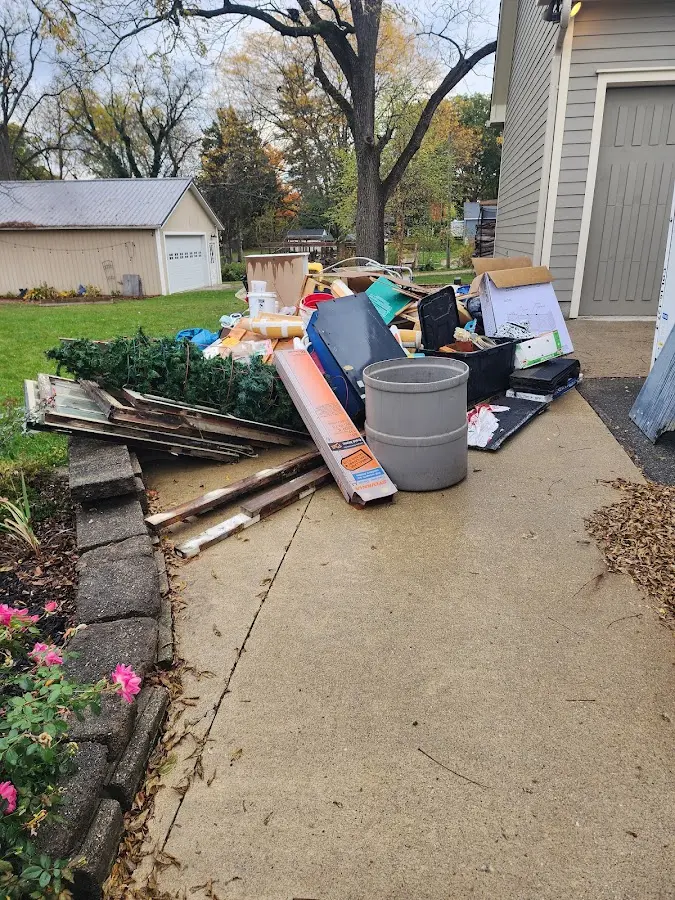 Dumpster being loaded with debris for Estate Cleanout Dumpster Rental in Chicopee